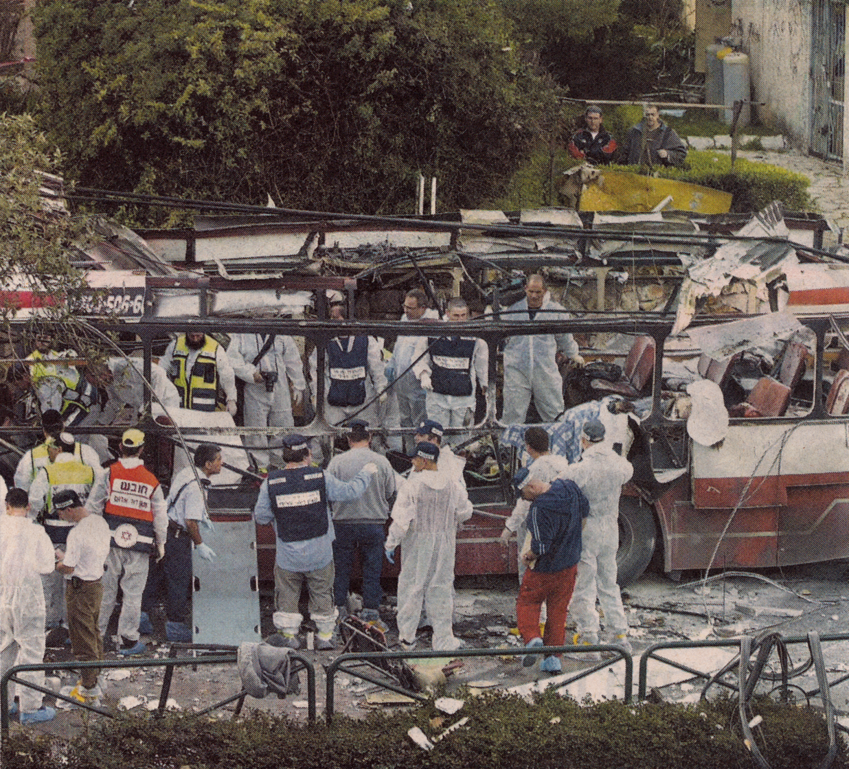 Rescue workers and police at the wreckage of a bus in Haifa after the March 5, 2003 bombing