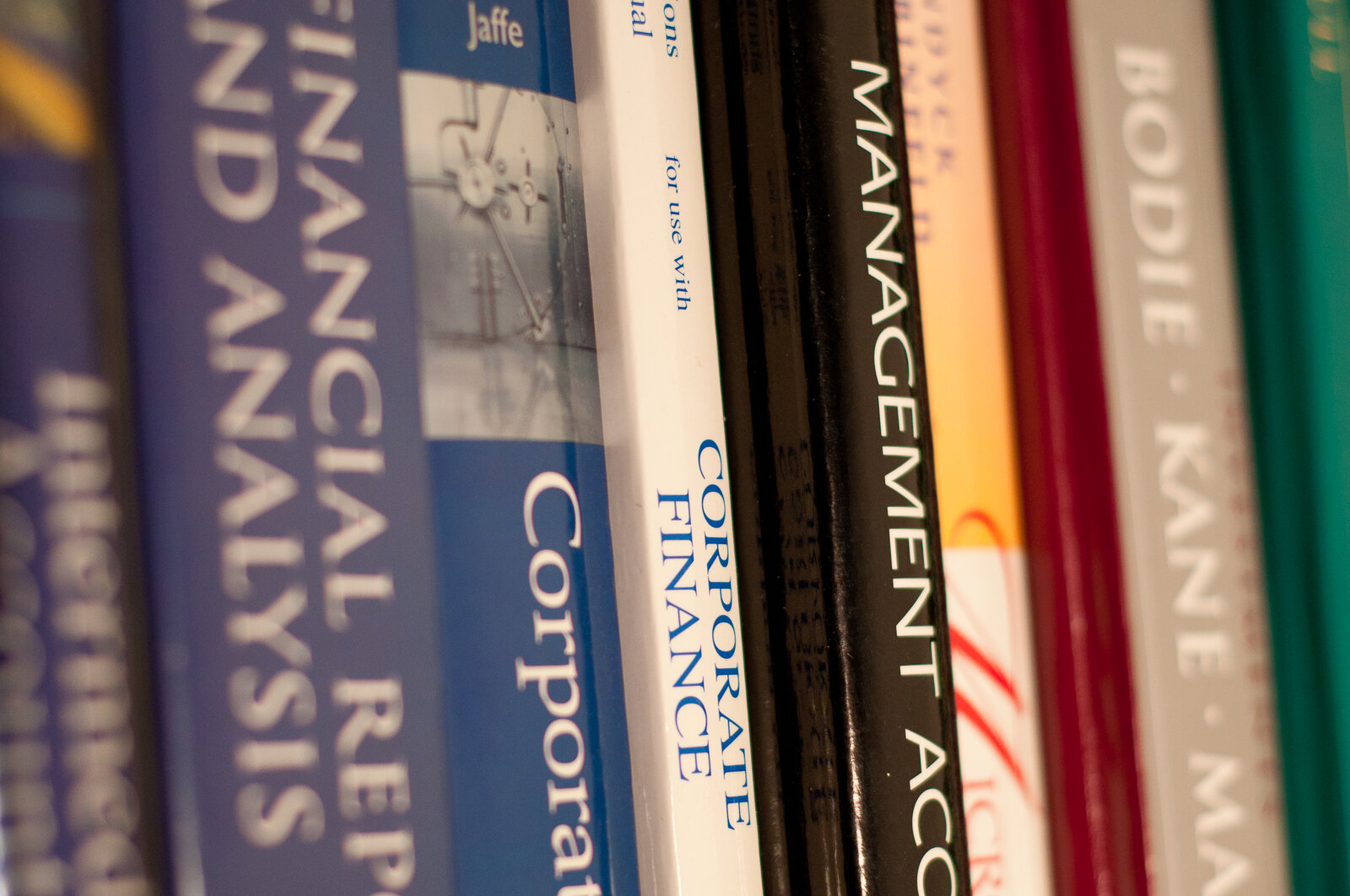 A close-up photograph of a collection of textbooks